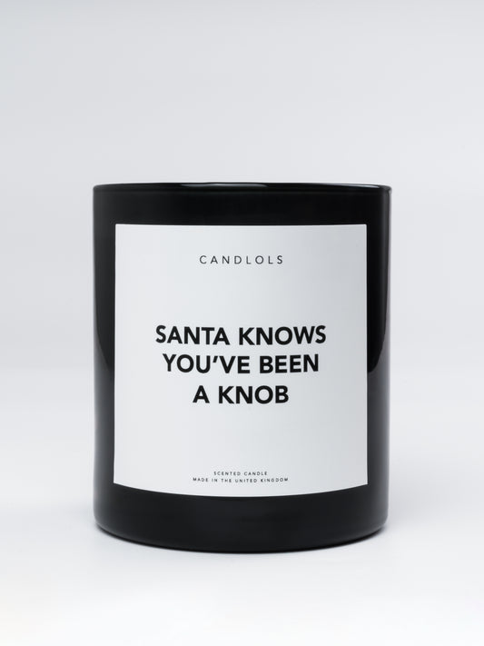 'Santa knows you've been a knob' candle